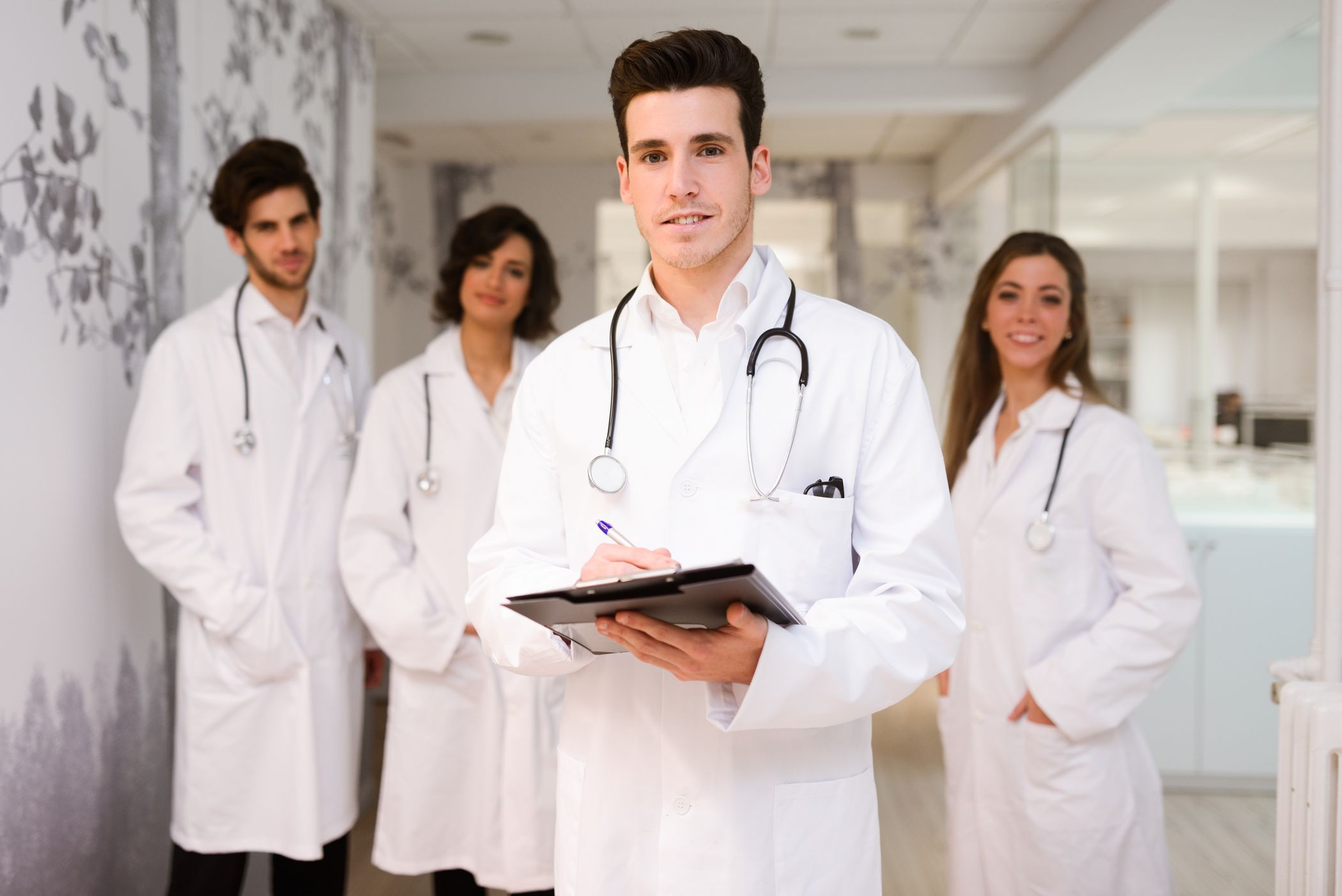 A group of doctors smiling and looking at the camera